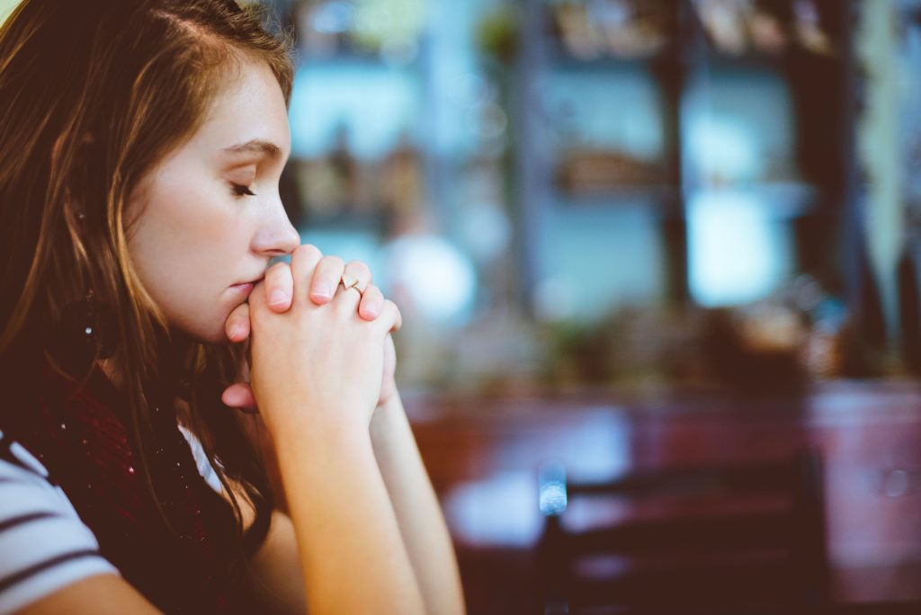 woman kneeling praying